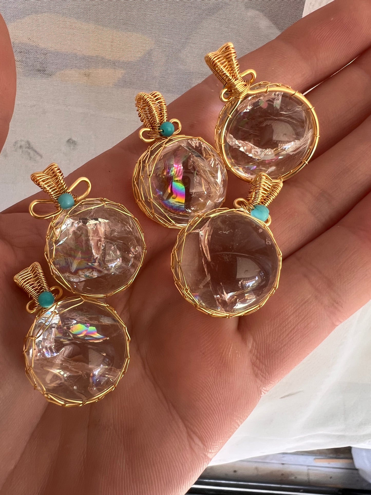 Rainbow filled clear quartz wire wrapped pendants