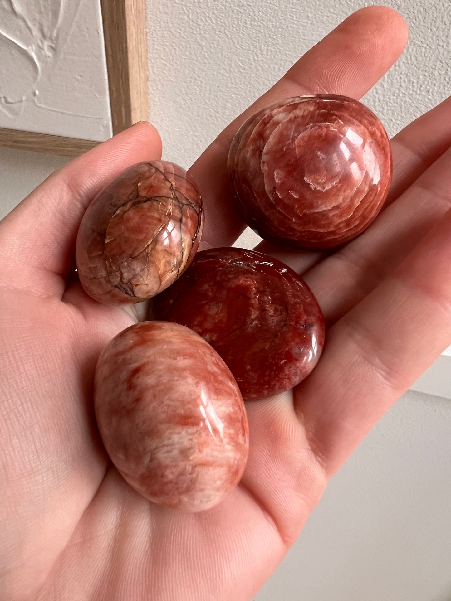 Red feldspar palm tumbles