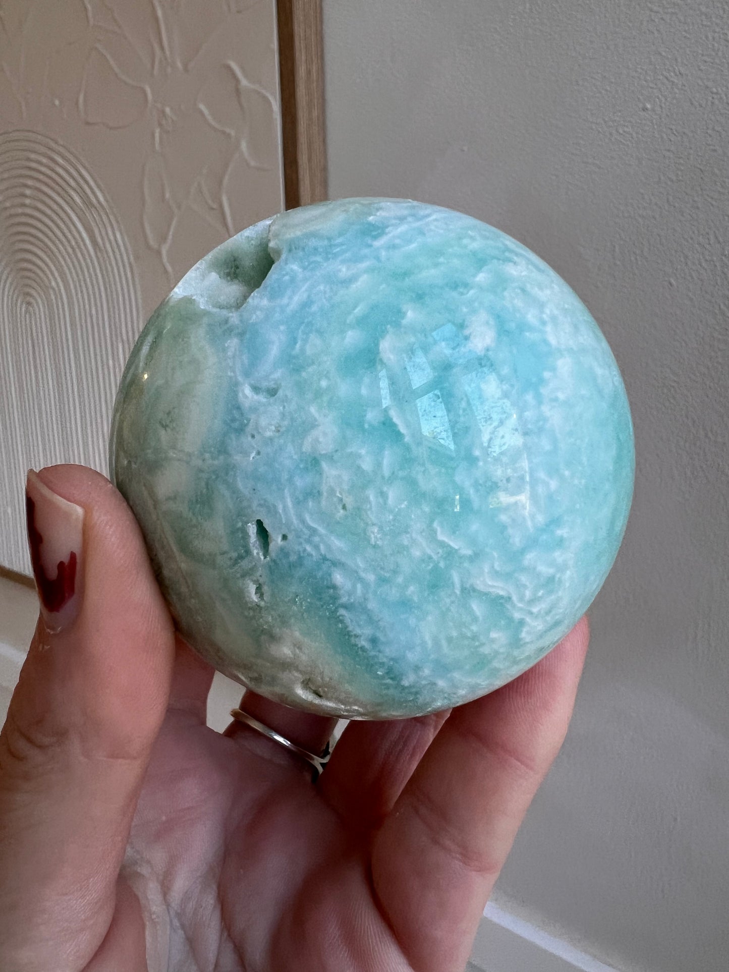 Blue aragonite sphere with caves