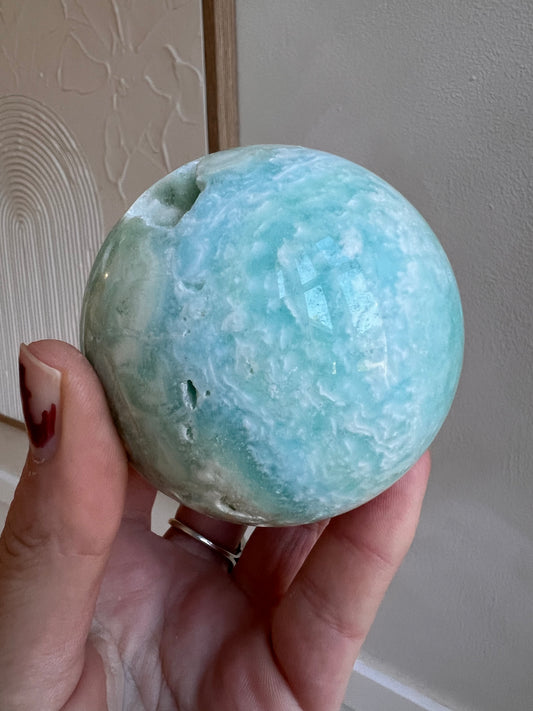 Blue aragonite sphere with caves